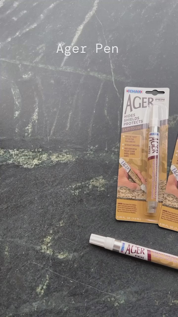 Tenax Ager Pen applied to a dark natural stone surface